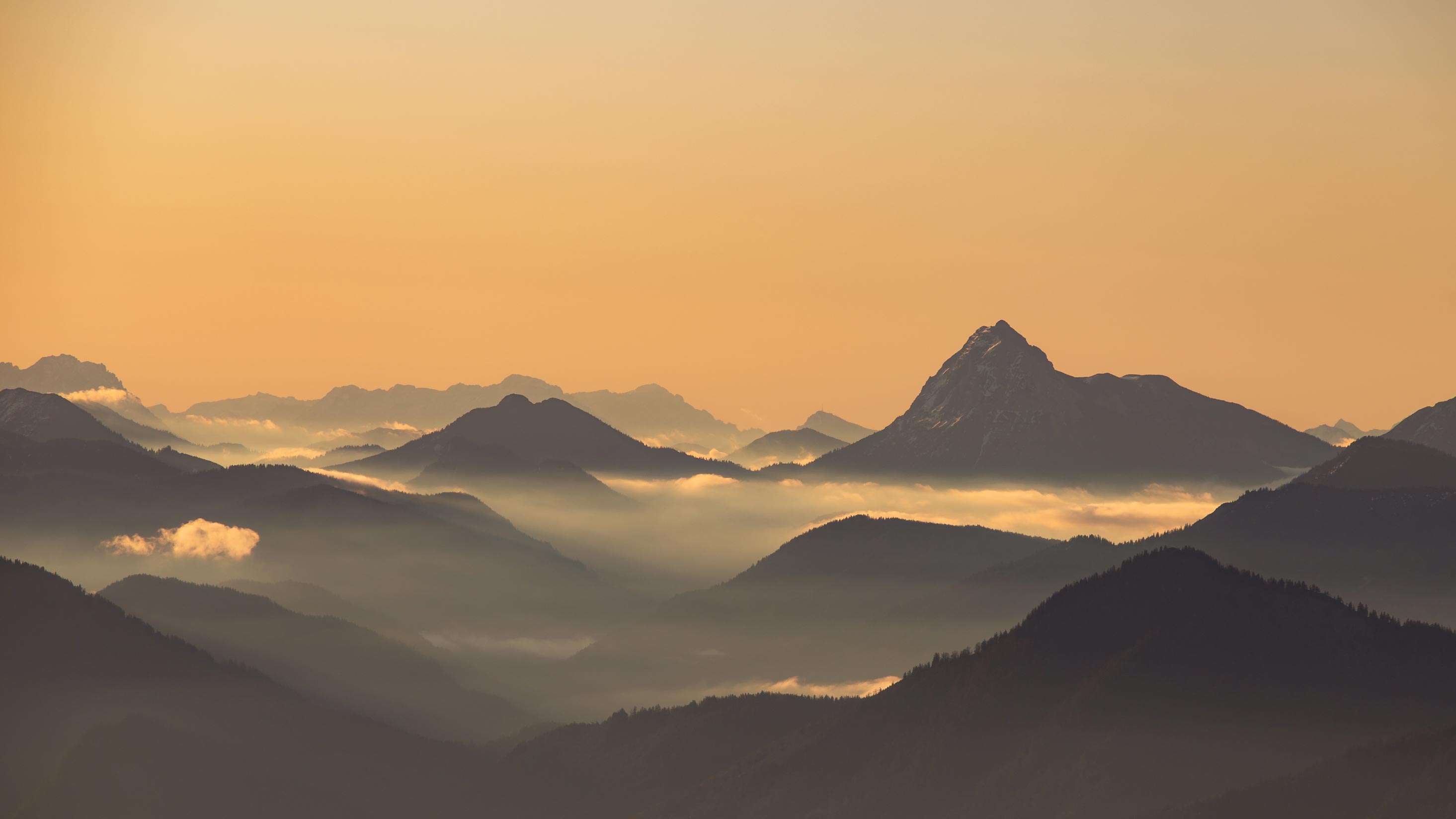 Mountain range emerging from morning mist in black and white